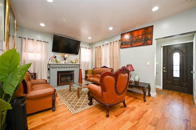 living room featuring a fireplace and light hardwood / wood-style flooring