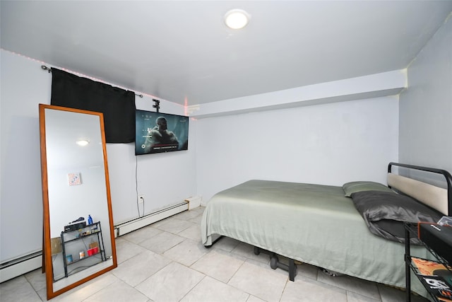 bedroom featuring a baseboard heating unit and light tile patterned floors