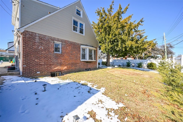 view of snow covered exterior with a yard