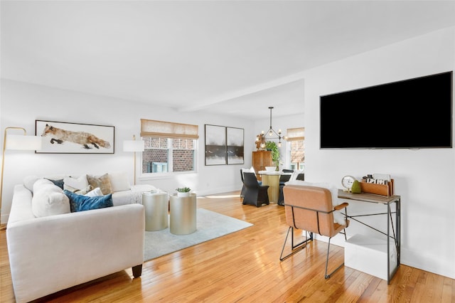 living room featuring a notable chandelier and wood-type flooring