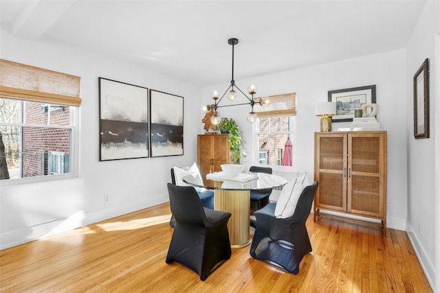 dining room featuring an inviting chandelier and light wood-type flooring