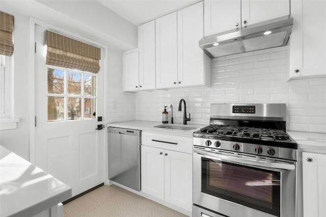 kitchen featuring white cabinetry, appliances with stainless steel finishes, sink, and light stone counters