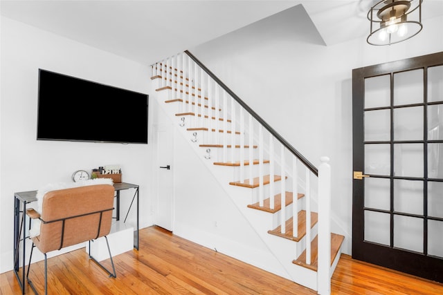 stairs featuring hardwood / wood-style flooring