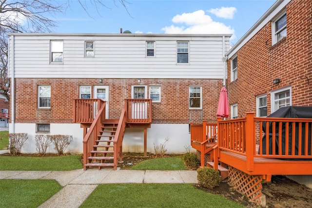 back of property featuring a wooden deck