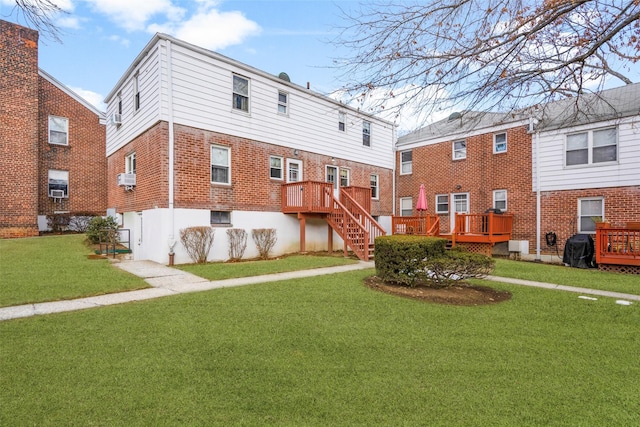 back of house featuring a deck and a lawn