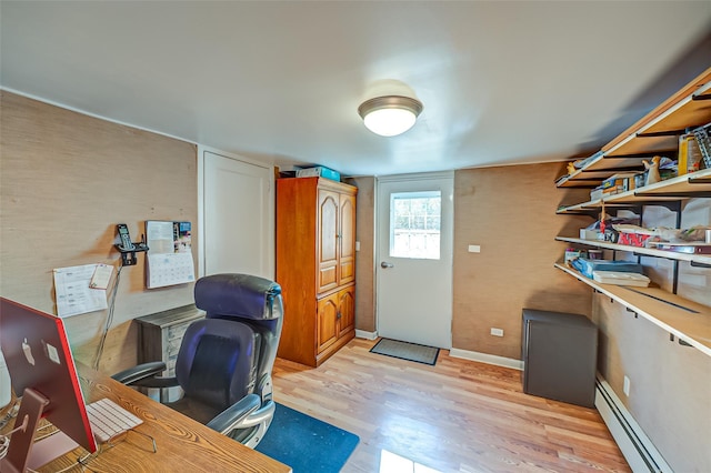 home office featuring baseboard heating and light hardwood / wood-style flooring