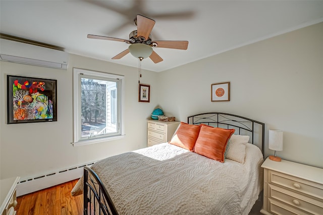 bedroom with a baseboard heating unit, hardwood / wood-style flooring, a wall unit AC, and ceiling fan