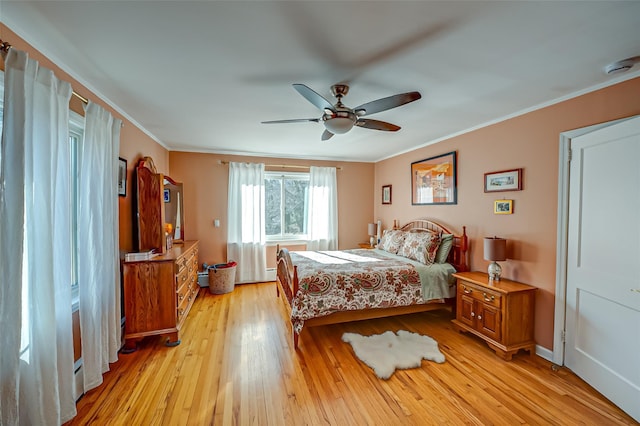 bedroom featuring crown molding, light hardwood / wood-style flooring, and ceiling fan