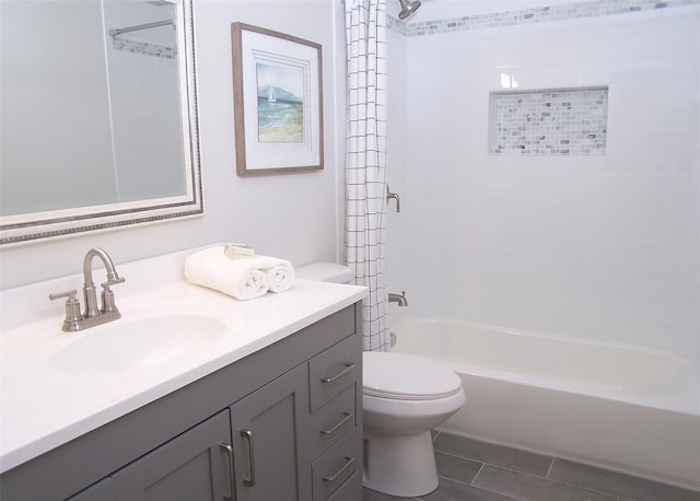 full bathroom with tiled shower / bath, vanity, and toilet