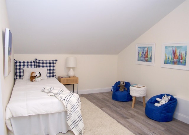 bedroom featuring wood-type flooring and vaulted ceiling