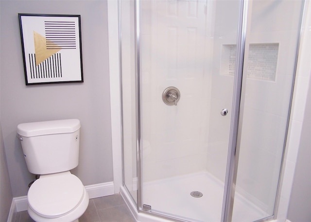 bathroom with walk in shower, toilet, and tile patterned flooring