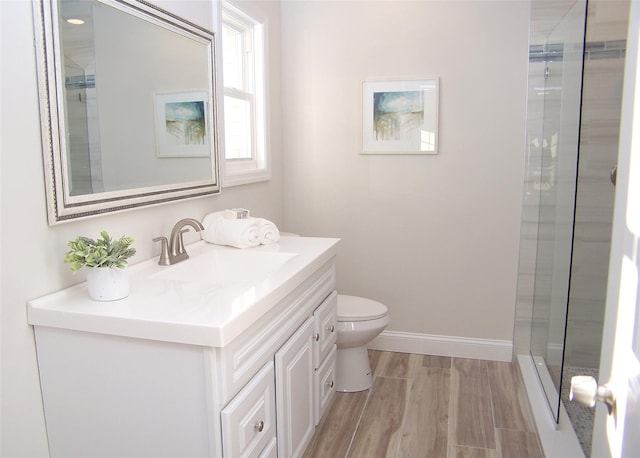 bathroom featuring vanity, an enclosed shower, and toilet