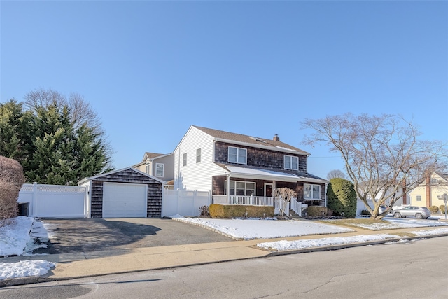 front of property featuring an outbuilding, a garage, and covered porch