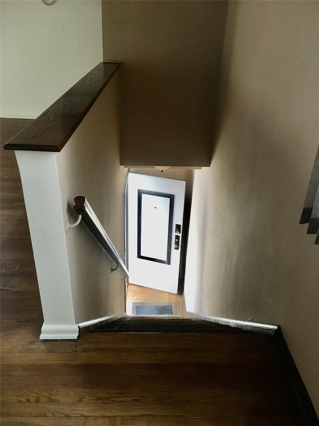 stairs with hardwood / wood-style floors