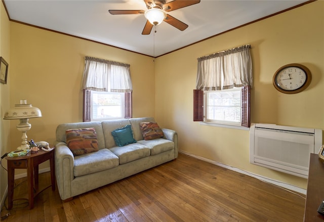 living room featuring heating unit, hardwood / wood-style floors, plenty of natural light, and ceiling fan