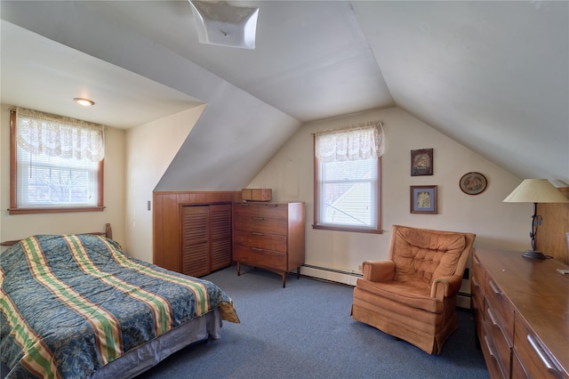 bedroom with baseboard heating, vaulted ceiling, and dark colored carpet