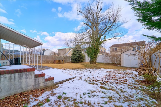 snowy yard with a storage shed