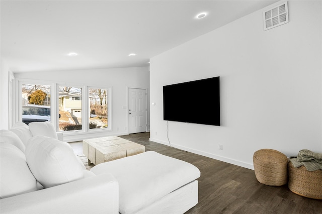 living room with lofted ceiling and dark hardwood / wood-style floors