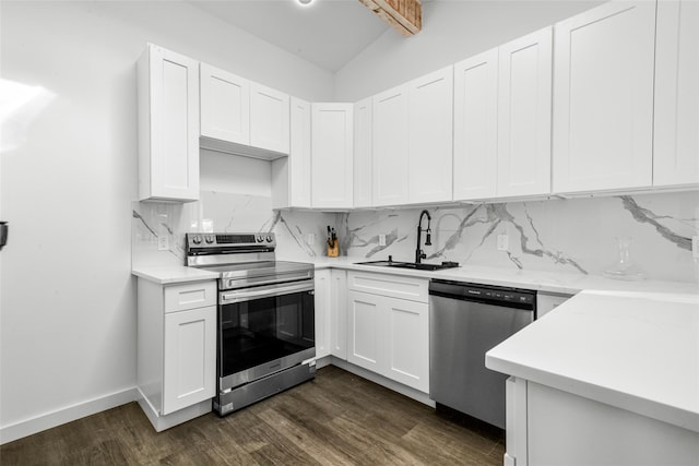 kitchen featuring dark wood-type flooring, sink, appliances with stainless steel finishes, decorative backsplash, and white cabinets