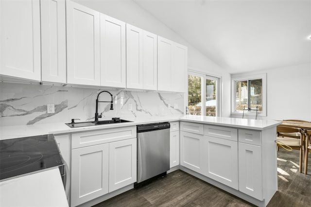 kitchen featuring white cabinetry, vaulted ceiling, kitchen peninsula, and appliances with stainless steel finishes