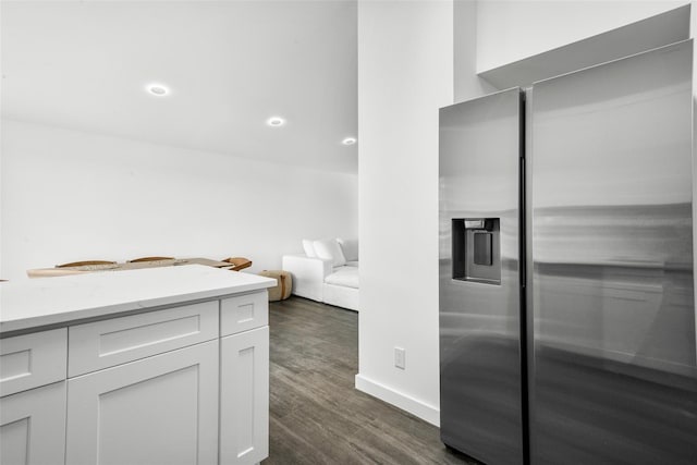 kitchen featuring white cabinetry, stainless steel fridge with ice dispenser, and dark wood-type flooring