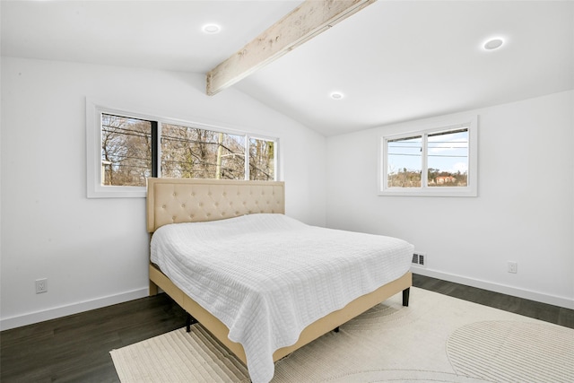 bedroom with dark hardwood / wood-style flooring and vaulted ceiling with beams