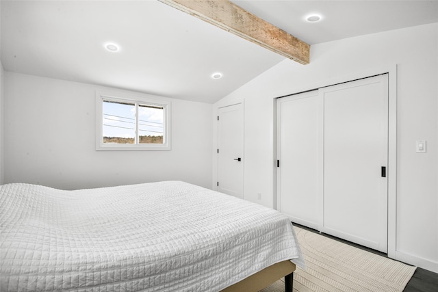 bedroom with hardwood / wood-style floors and lofted ceiling with beams