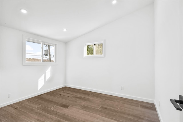 empty room with lofted ceiling and dark hardwood / wood-style floors