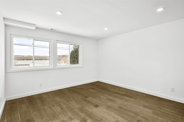 empty room featuring dark hardwood / wood-style flooring