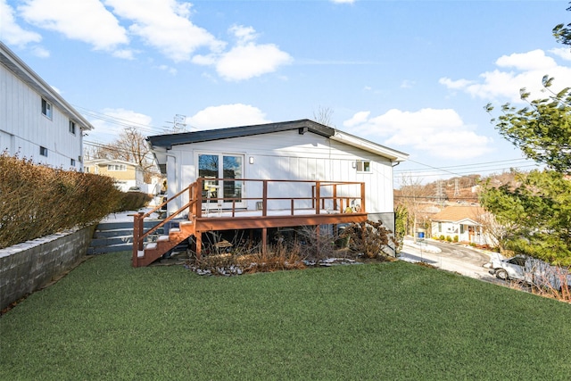 back of property featuring a yard and a deck