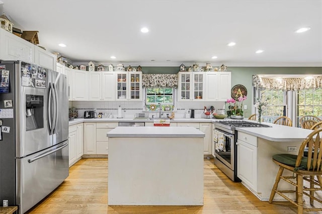 kitchen with white cabinetry, appliances with stainless steel finishes, and a kitchen island