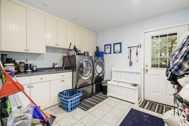 laundry room featuring cabinets, independent washer and dryer, sink, and light tile patterned floors