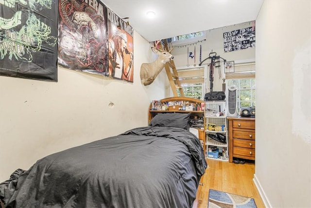 bedroom with hardwood / wood-style flooring