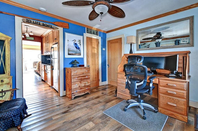 home office featuring crown molding, ceiling fan, and wood-type flooring