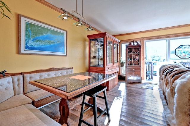 dining area with wood-type flooring and ornamental molding