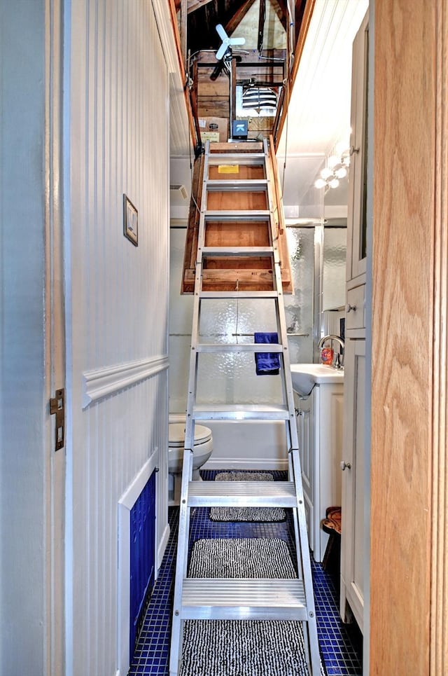 stairs with sink and tile patterned floors