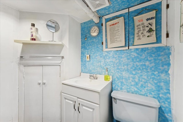 bathroom featuring vanity and toilet