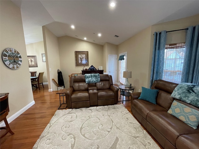 living room with hardwood / wood-style flooring and lofted ceiling