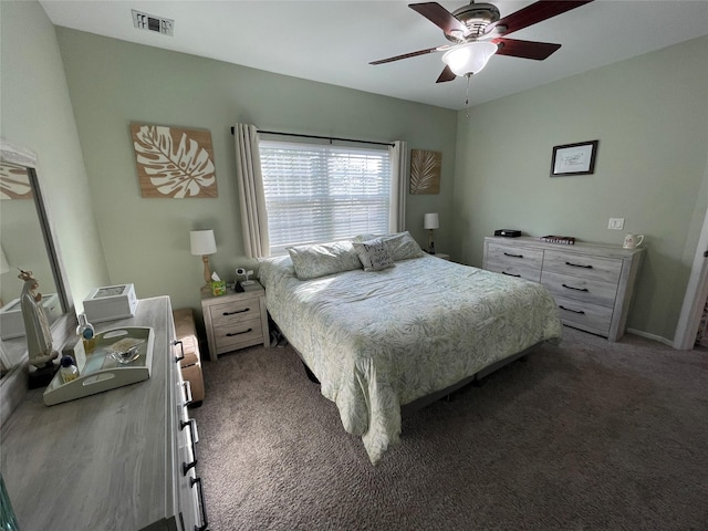 bedroom with ceiling fan and dark carpet