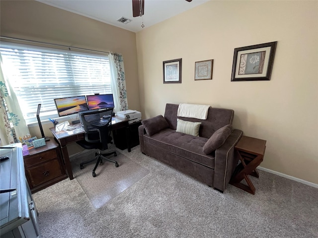 carpeted office space with ceiling fan