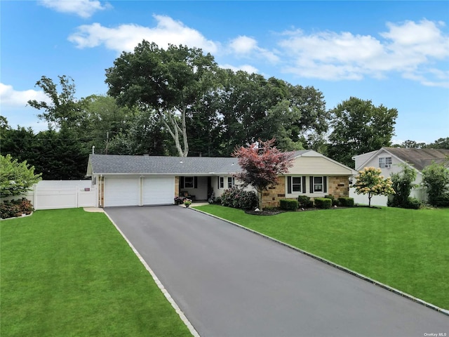 ranch-style house with a garage and a front yard