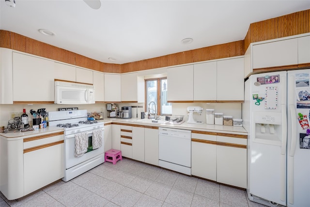 kitchen featuring sink, white appliances, and white cabinets