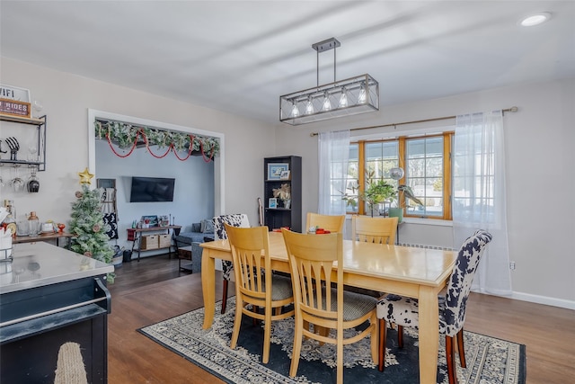 dining space with dark hardwood / wood-style flooring