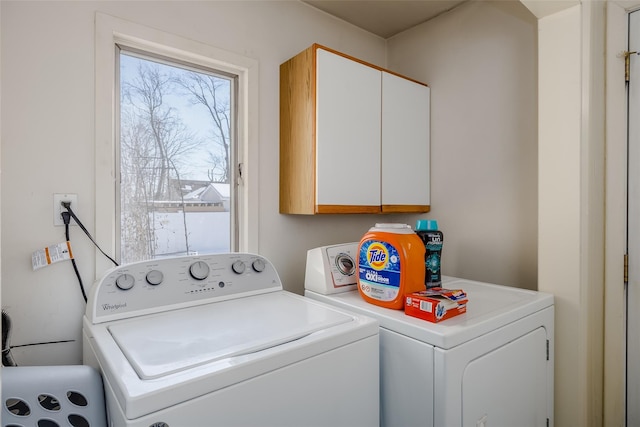 laundry area featuring cabinets and washing machine and dryer