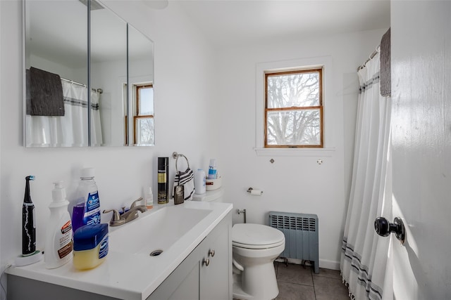 bathroom featuring vanity, radiator heating unit, tile patterned floors, and toilet