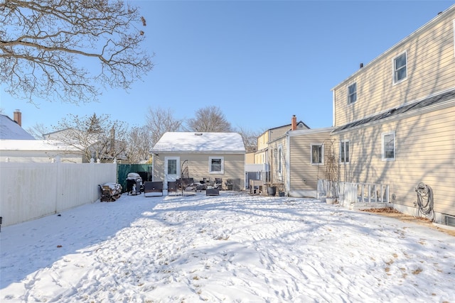 view of snow covered rear of property