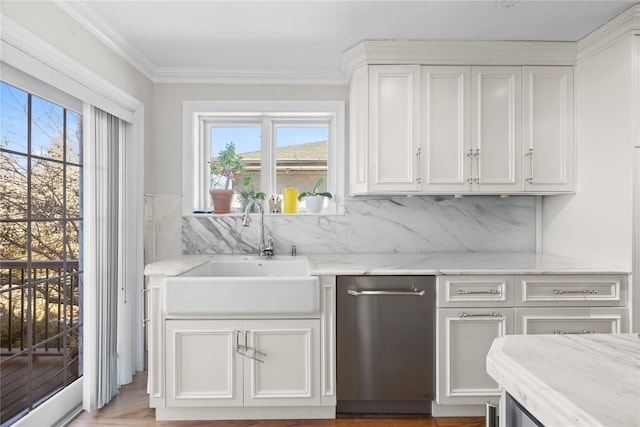 kitchen featuring white cabinetry, ornamental molding, sink, and light stone counters