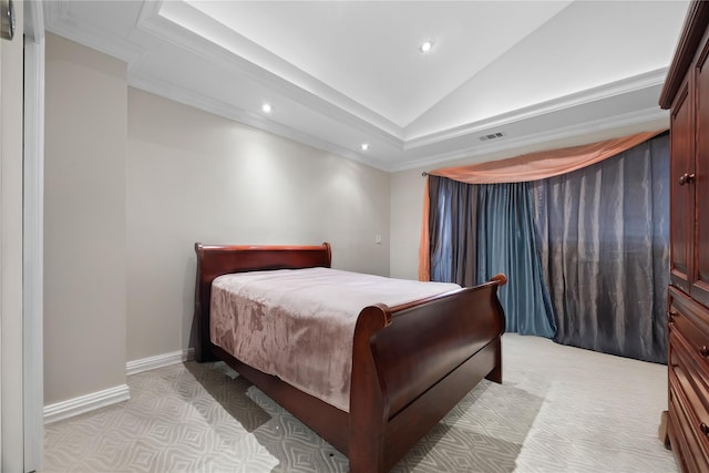 bedroom featuring a raised ceiling, ornamental molding, and light colored carpet