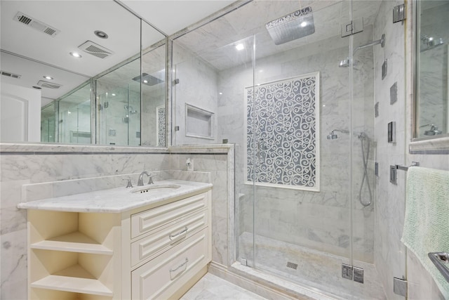 bathroom with vanity, tile walls, and walk in shower