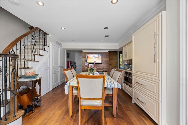 dining room featuring wood-type flooring and crown molding